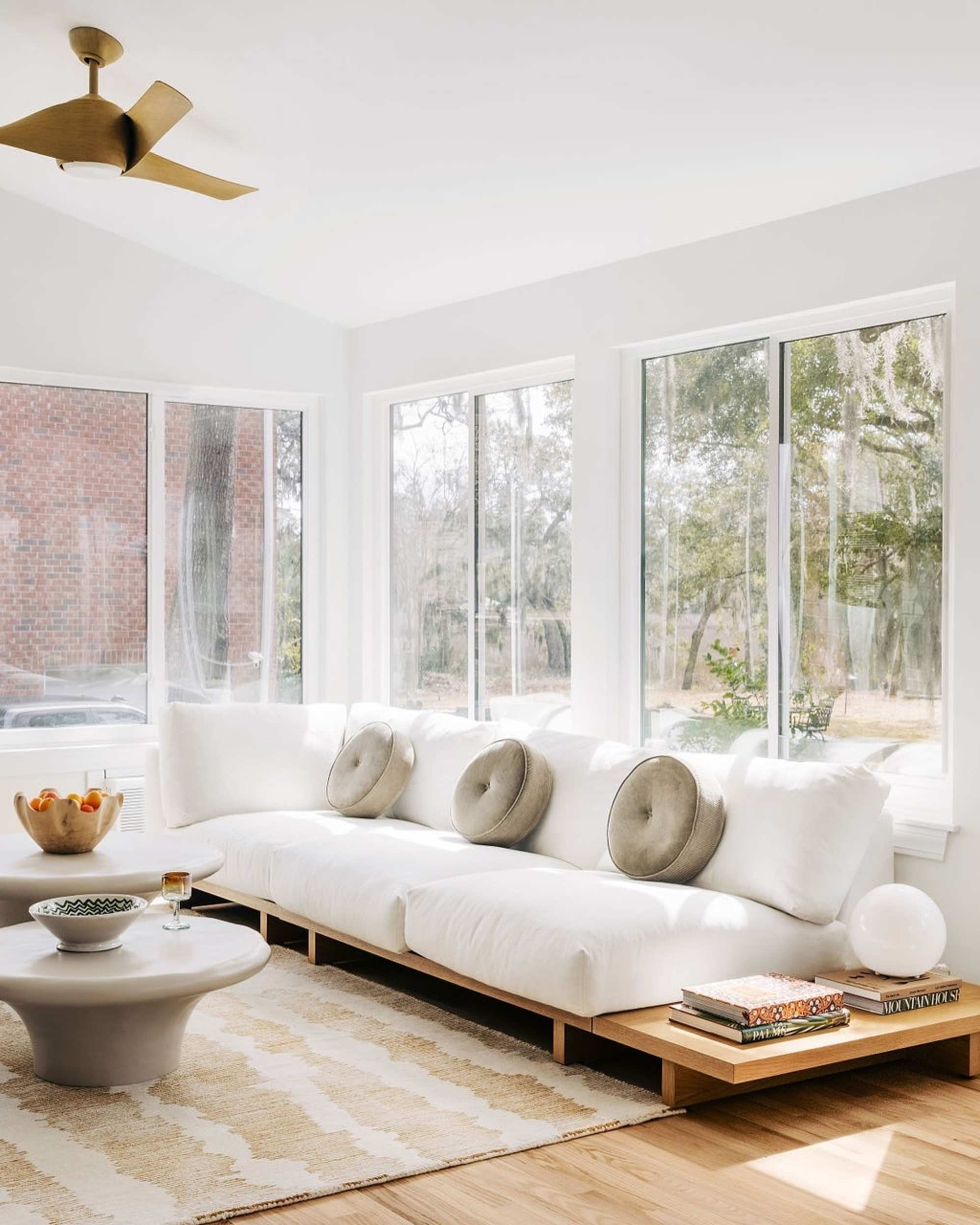 Brightly lit living room with white sofa