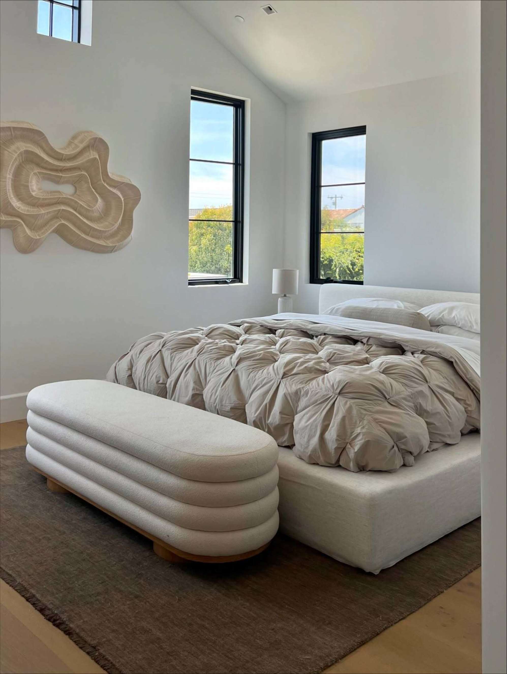 A white storage bed with storage bench in bedroom