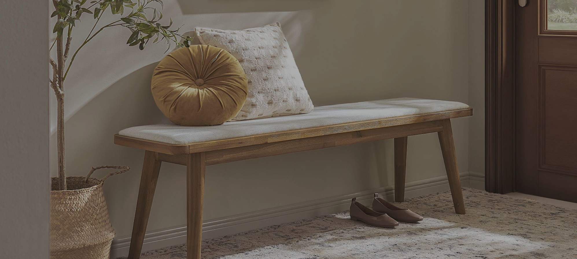 An acacia wood bench placed at the entryway.