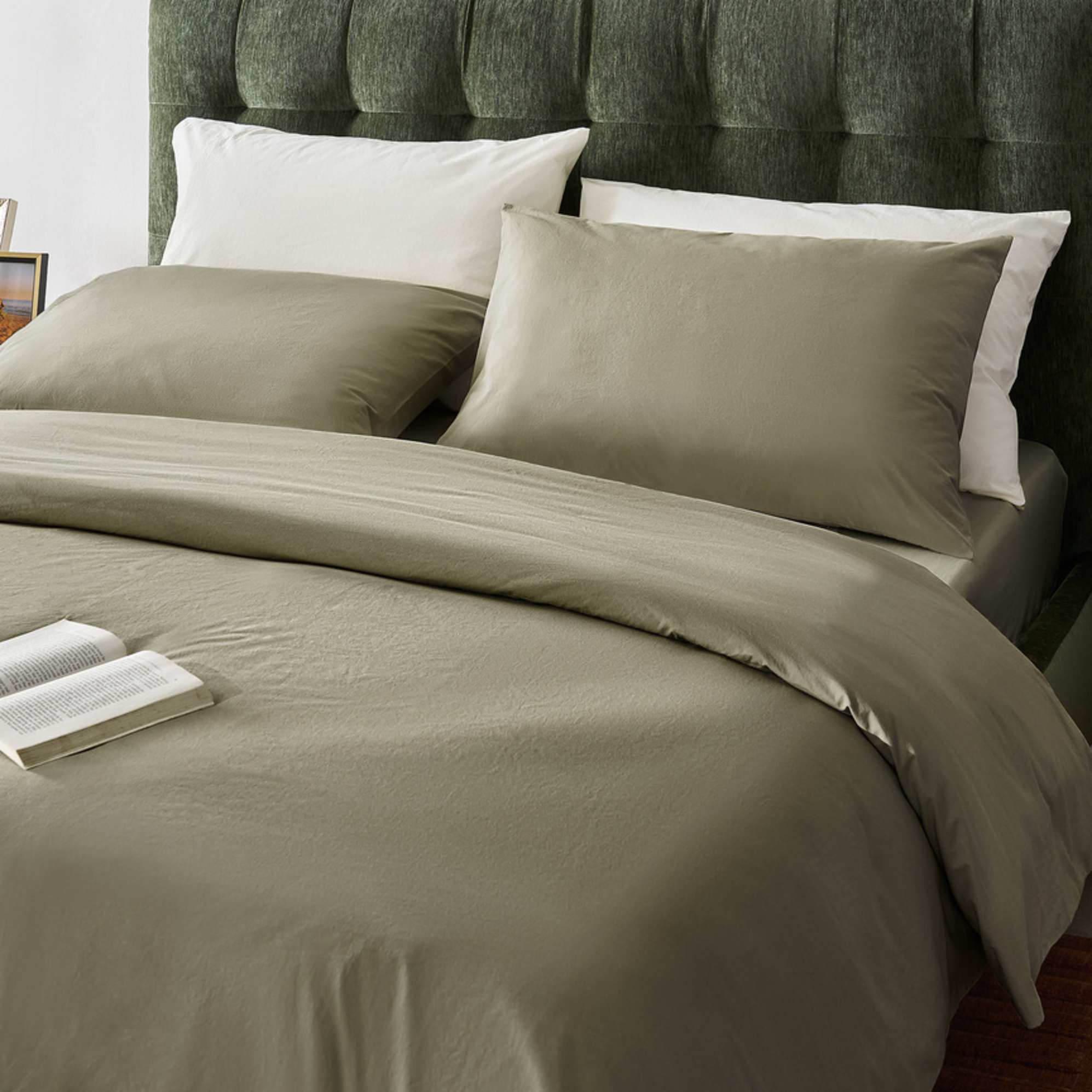 A moss green cotton percale bedsheet with matching pillow cases.