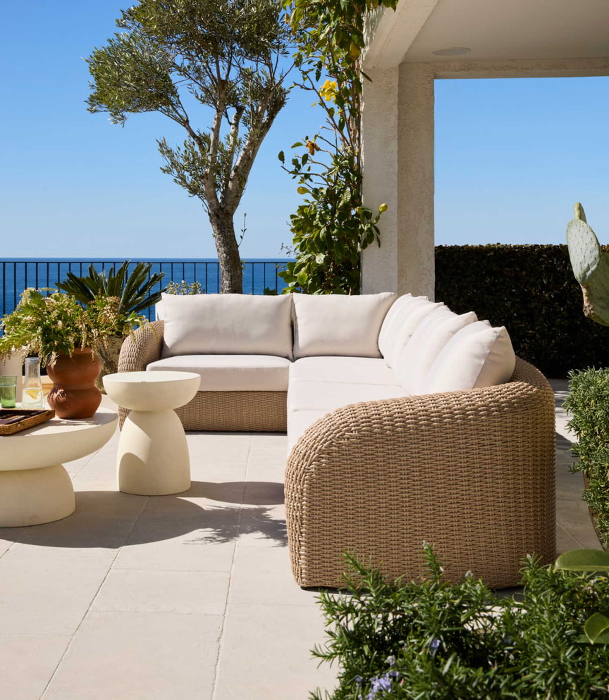 An outdoor L-shape wicker sectional sofa placed on a balcony.
