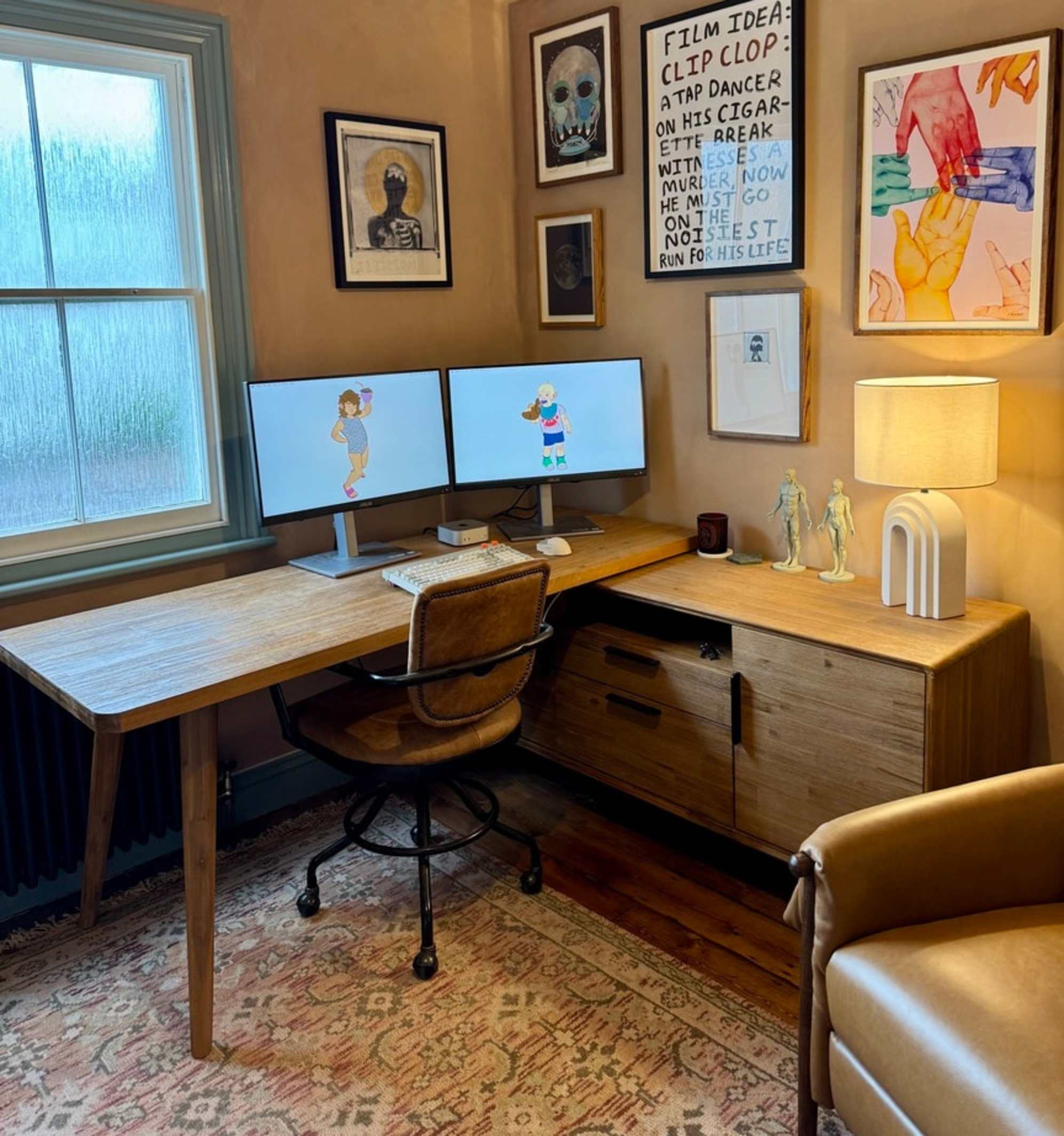 An acacia wood L-shaped desk placed in the corner of a room with two monitors.