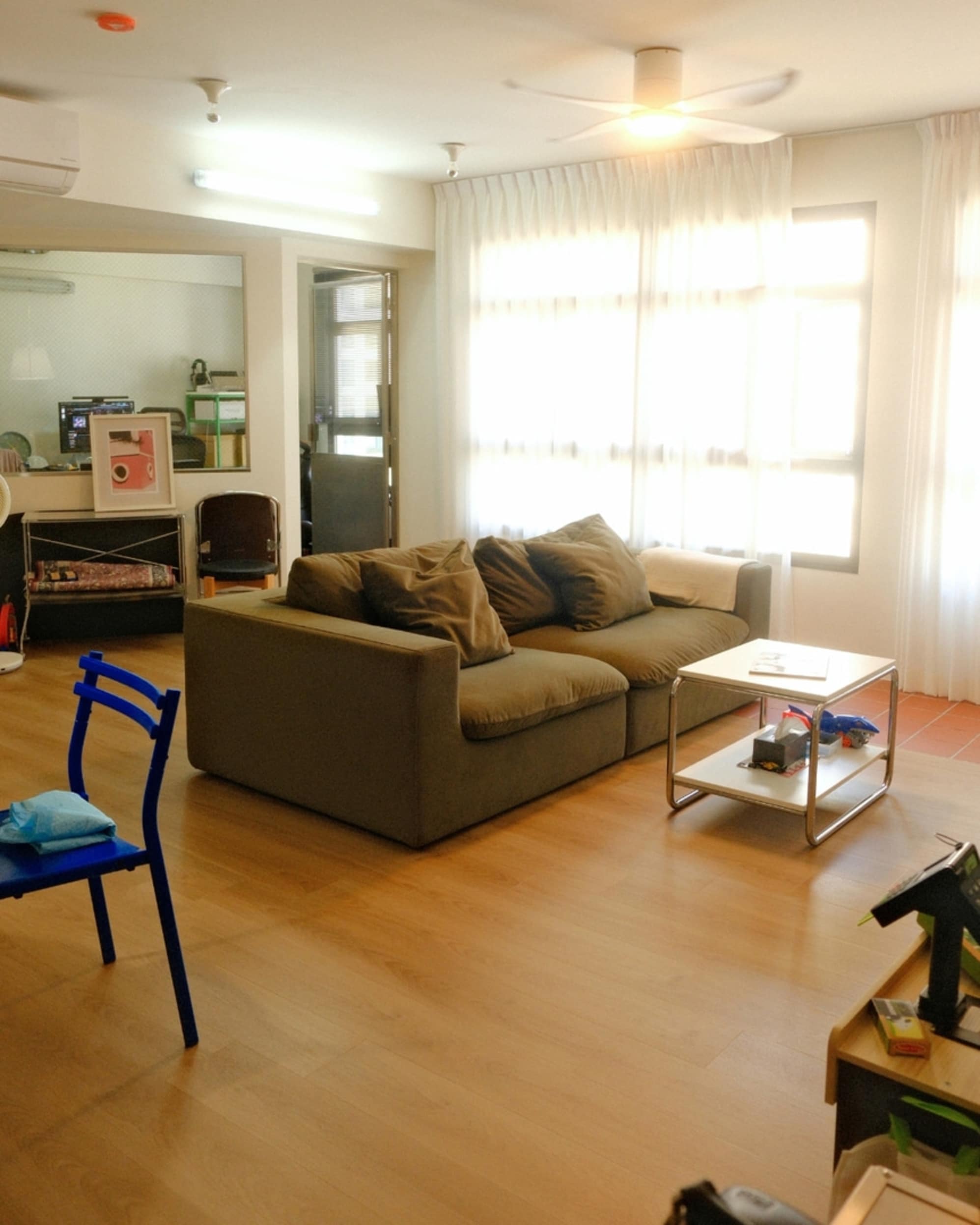 A moss green performance fabric sofa placed in a living space.