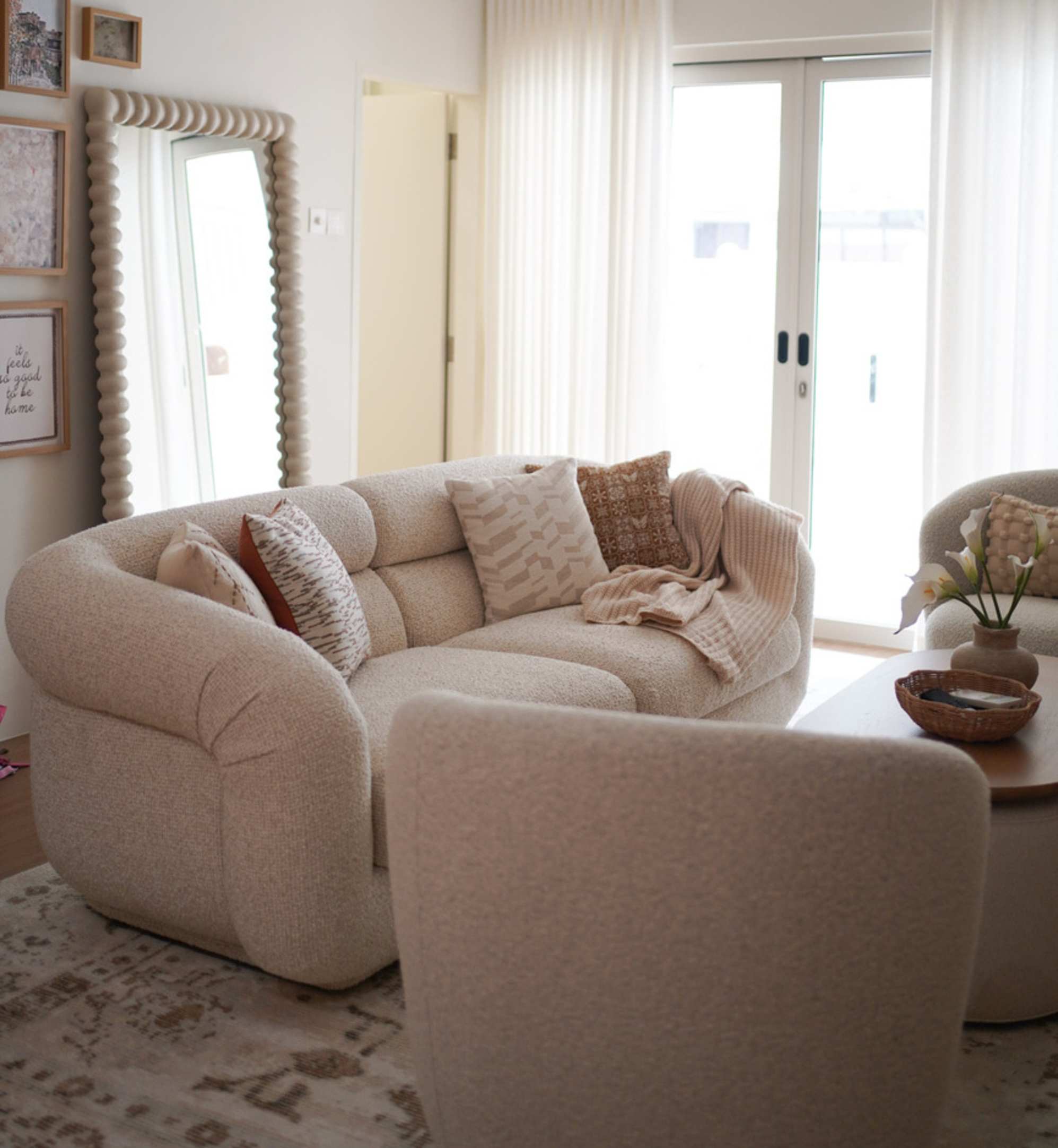 A chunky white 3-seater sofa placed in a living room.
