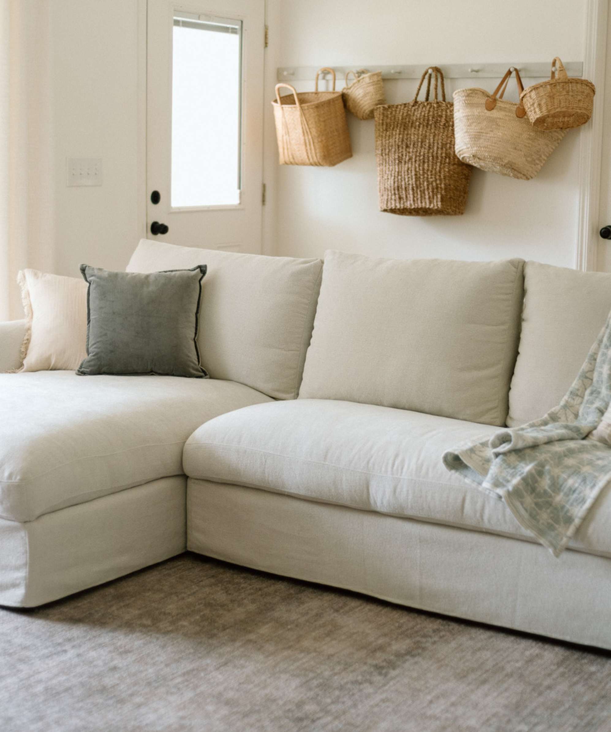 A chaise sectional storage sofa placed atop a grey rug.