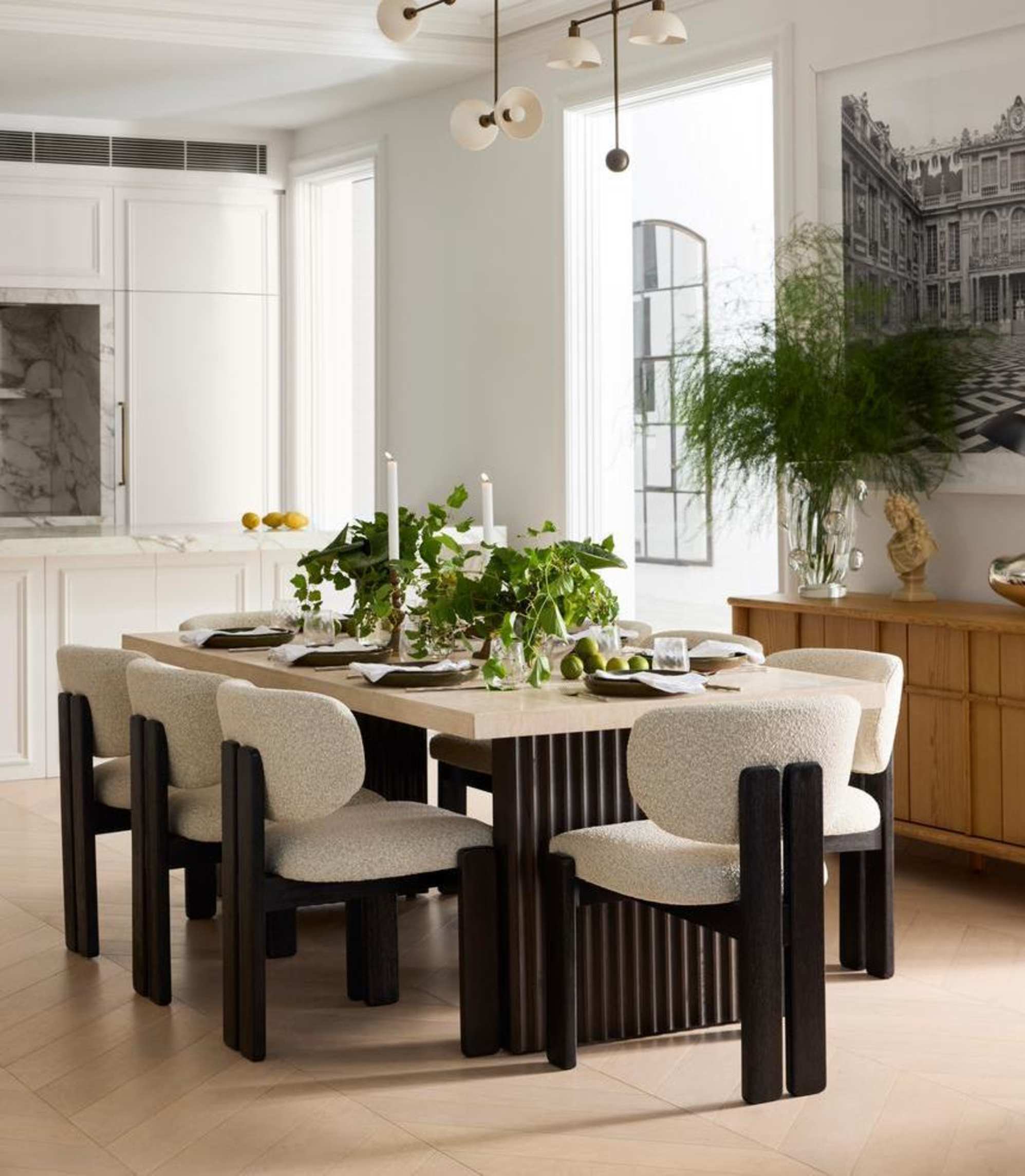 A rectangular travertine dining table with performance fabric dining chairs.