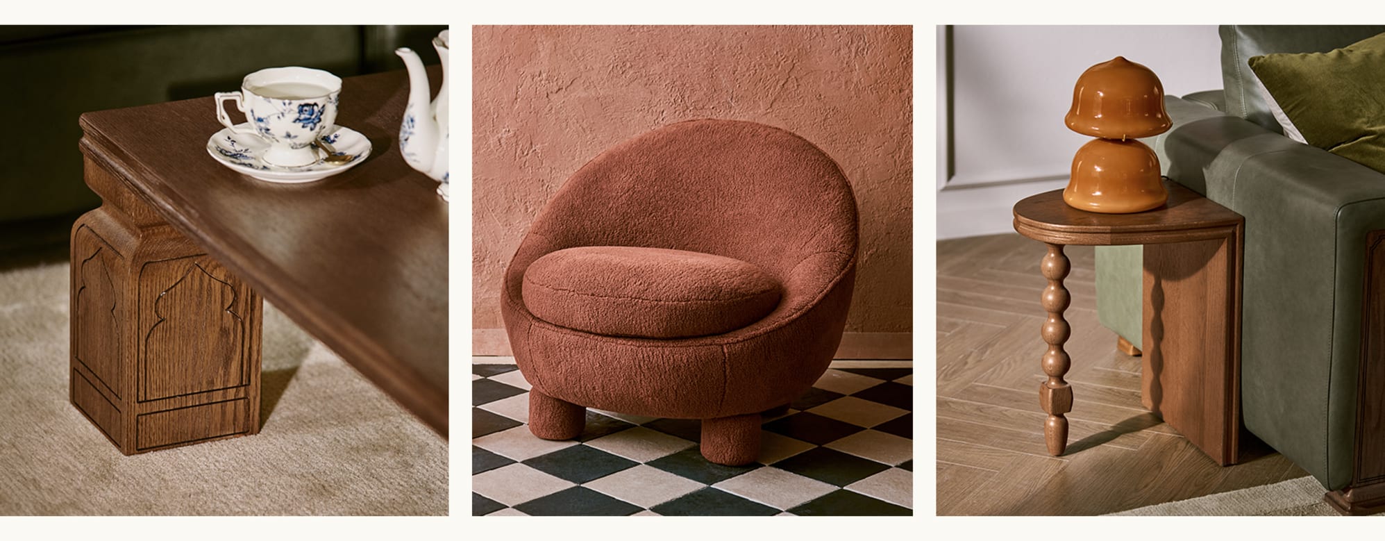 Tan France collection featuring a carved wood coffee table with teacup detail, a rust boucle armchair on checkered tile, and a turned-leg wood side table with lamp beside a green sofa.