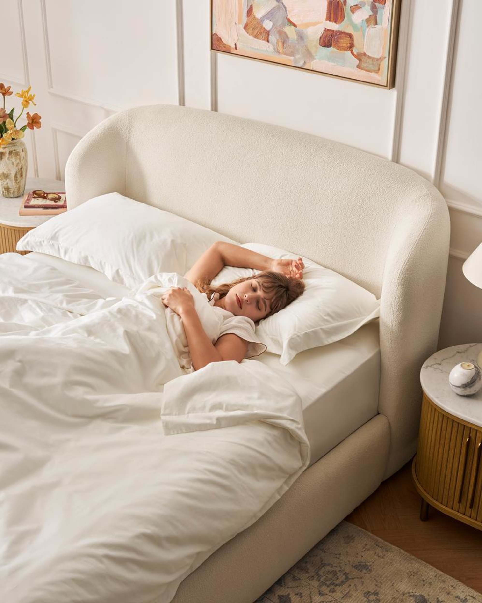 A person sleeping on their back on a bed.