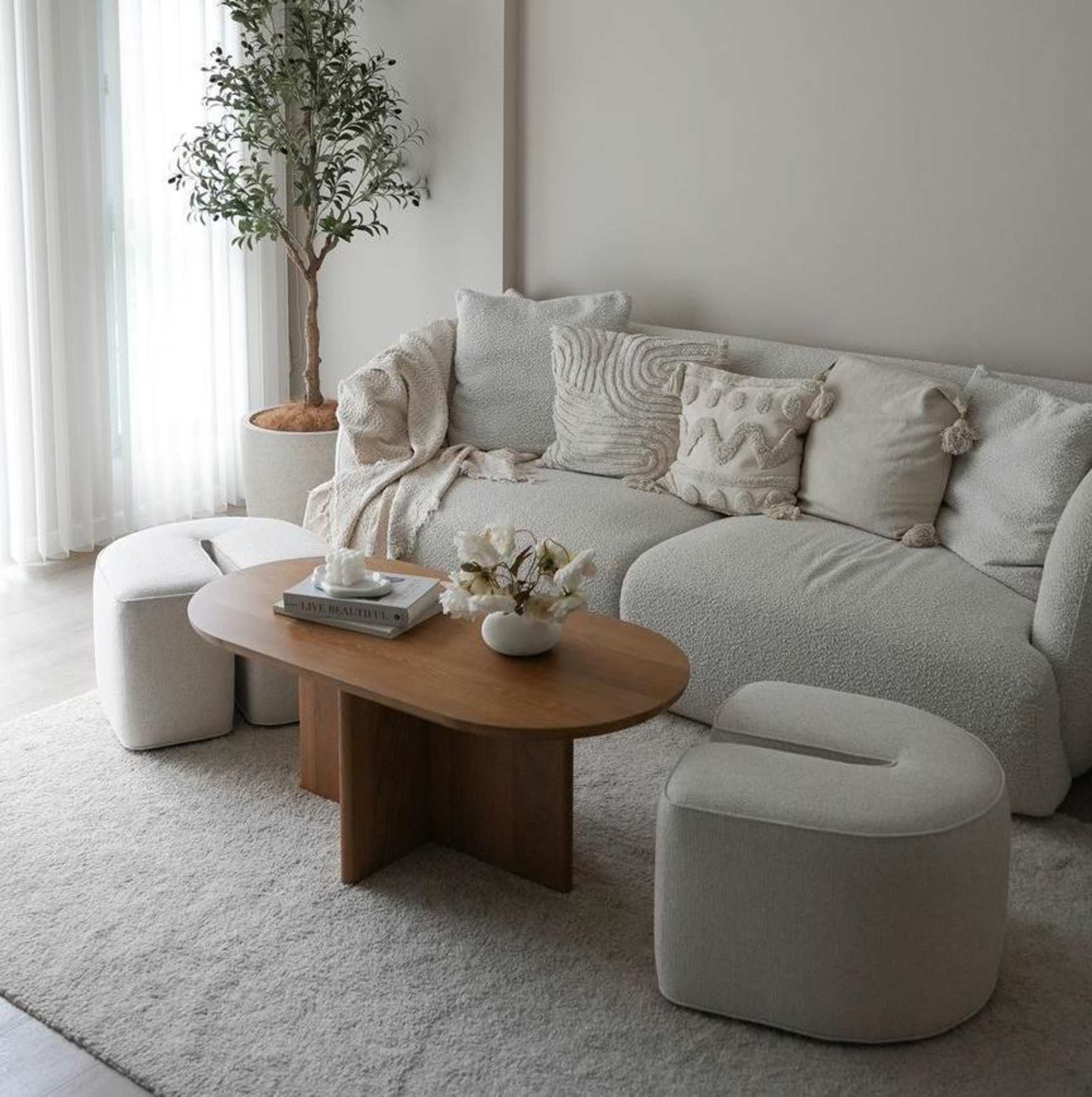 A nesting coffee table with its seats pulled out from the table.