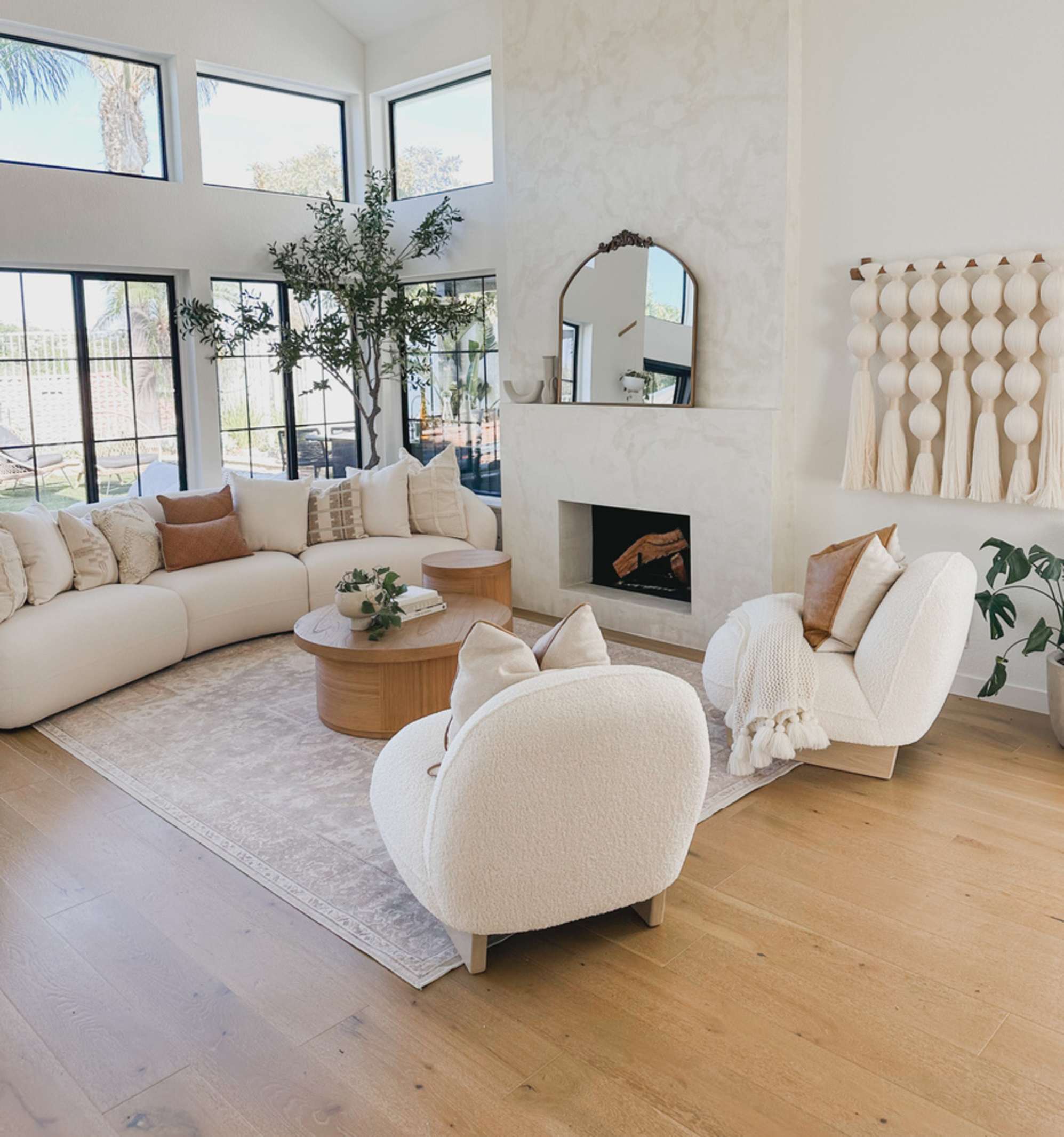 Two sherpa armchairs placed in the living room by a fireplace.