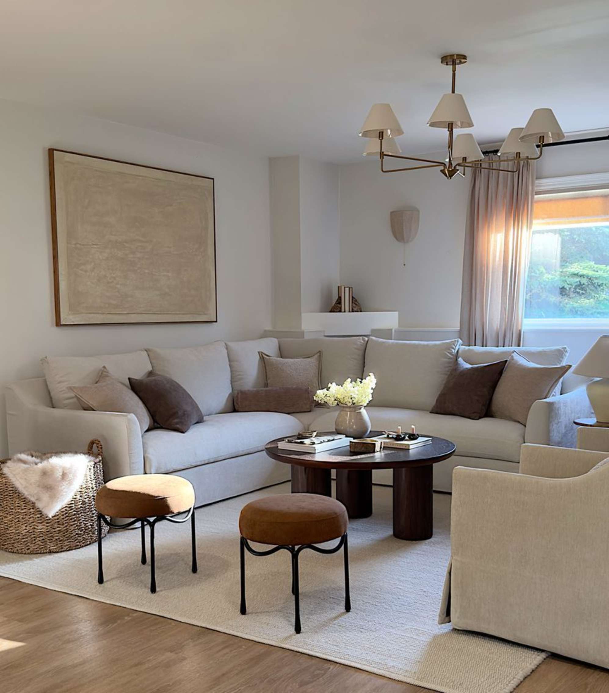 A white slipcover storage L-shaped sofa placed against the wall in a living room.