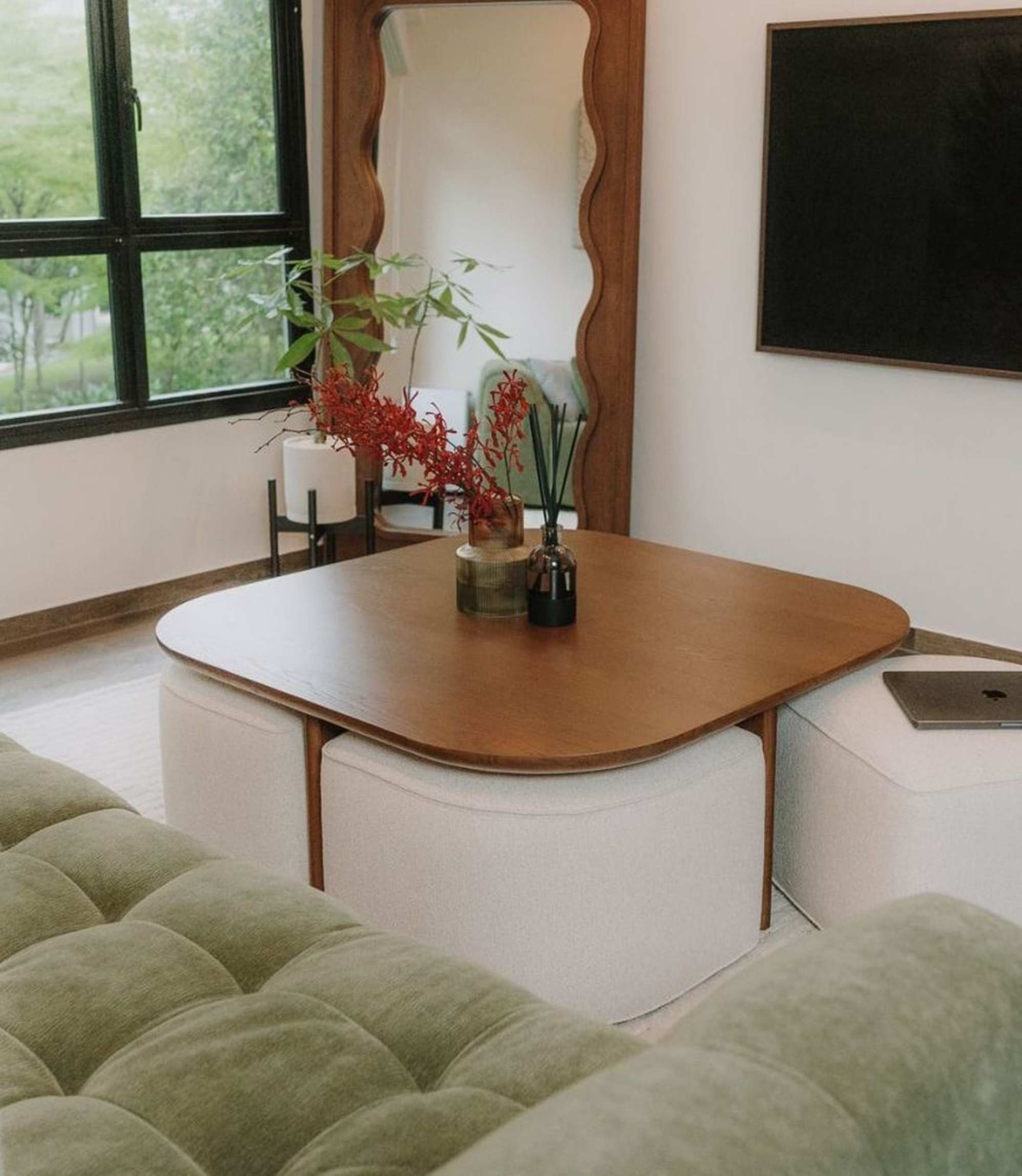 A square nesting coffee table with a potted plant and diffuser placed on the table top.