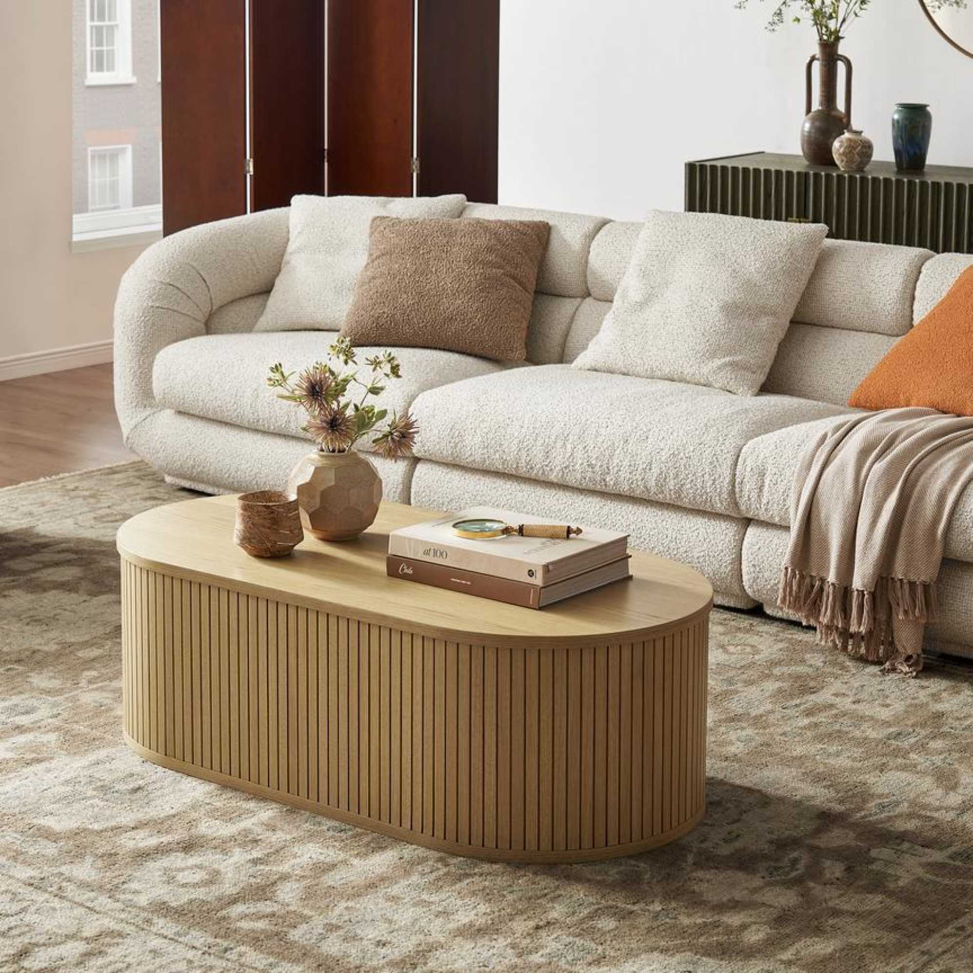 A rectangular coffee table with rounded edges placed in a living room.