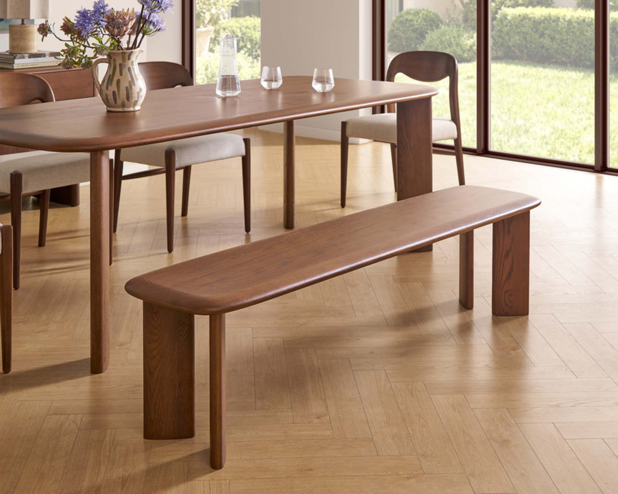A solid oak dining bench with a matching dining table.