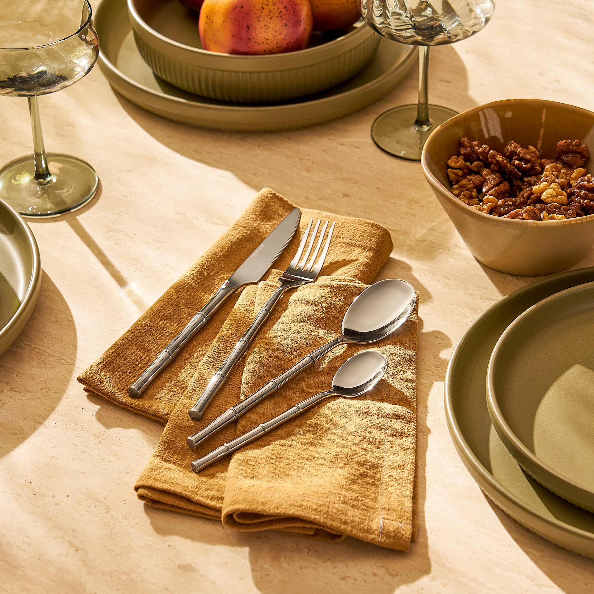Kai cutlery set of 4 on a table napkin. 