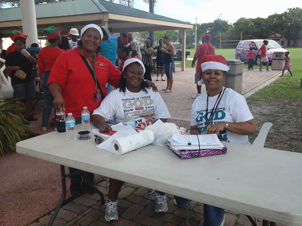 Mama Joy poses with community members at an event.