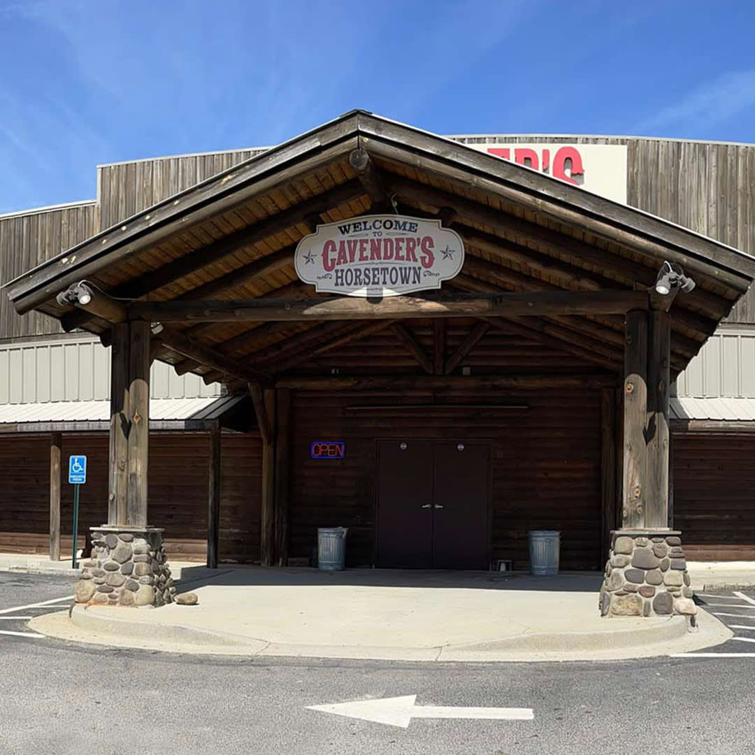 The image signifies a milestone for Cavender’s in 2020, as it marks the transition of three Horsetown stores to Cavender’s Horsetown in Georgia. The rustic wooden facade and stone pillars of the store, along with the welcoming sign, reflect the brand’s commitment to maintaining its western heritage while expanding its presence.