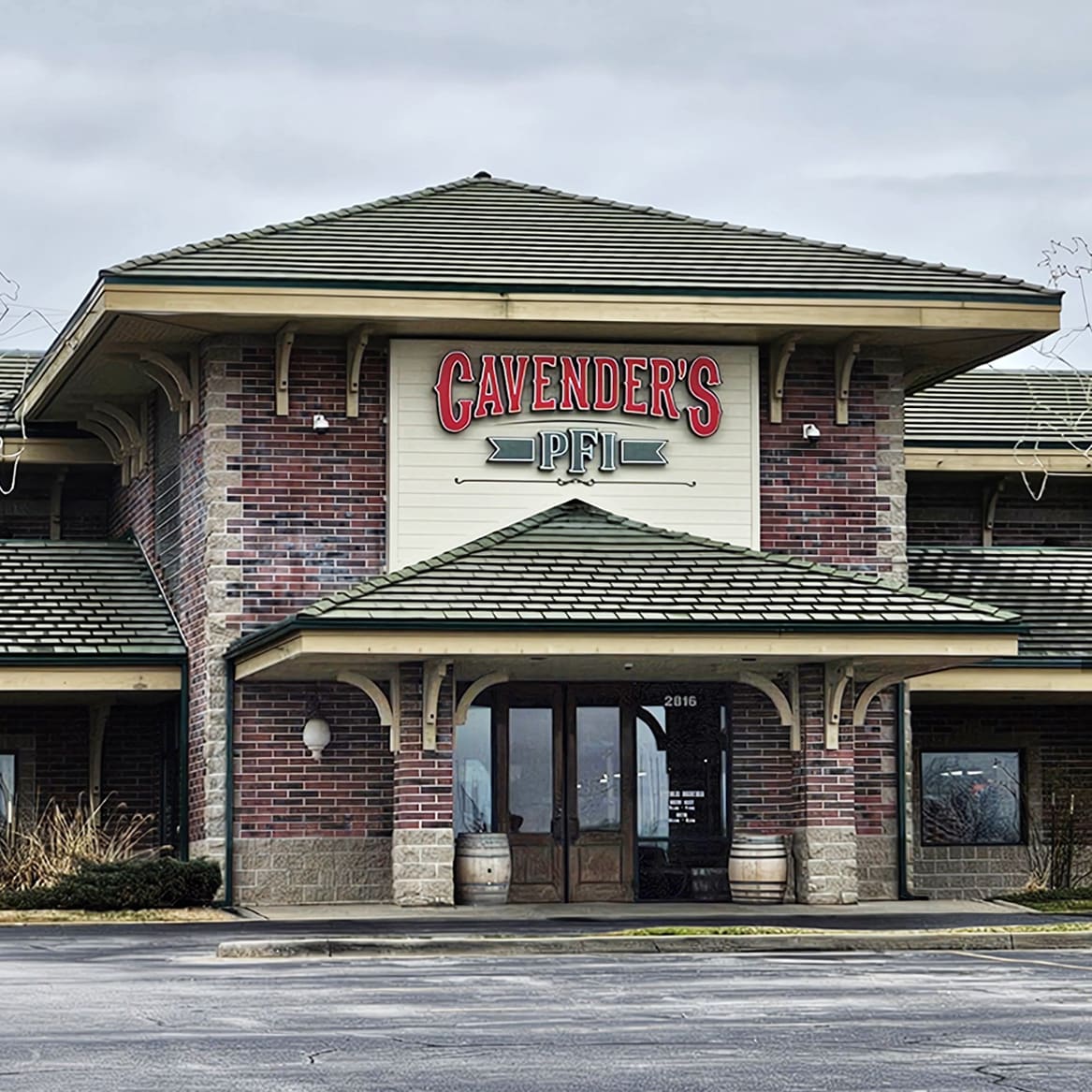 The image signifies Cavender’s expansion in 2021 through the acquisition of PFI Western, a family-owned western wear retailer in Springfield, MO. The storefront, with its brick facade and green gabled roof, reflects the merging of traditional western style with modern retail, marking a new chapter for both brands.