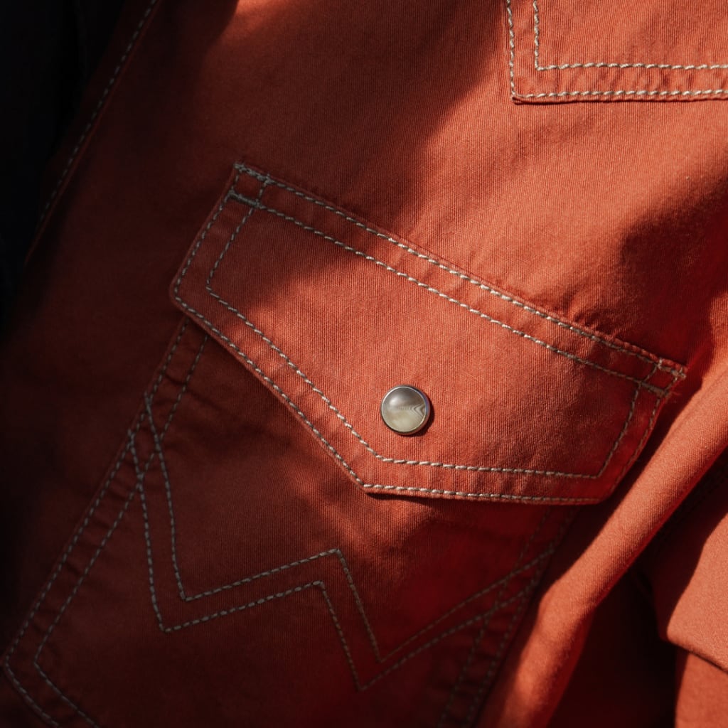 Close-up of Orange Wrangler Dress Shirt with a Pearl Snap Button Top Pocket Detail