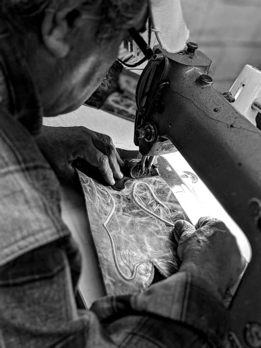 Black Jack artisan stitching a corded shaft