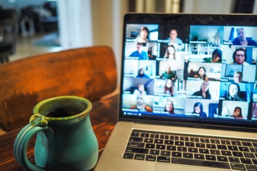 an open laptop computer shows a remote meeting in progress