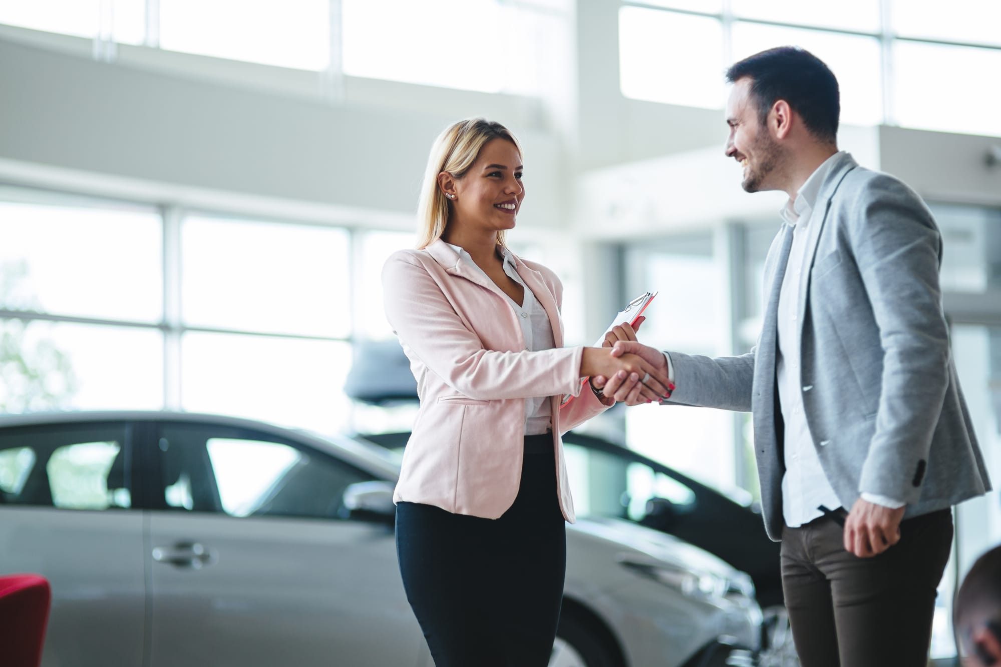 Couple buying car at dealership