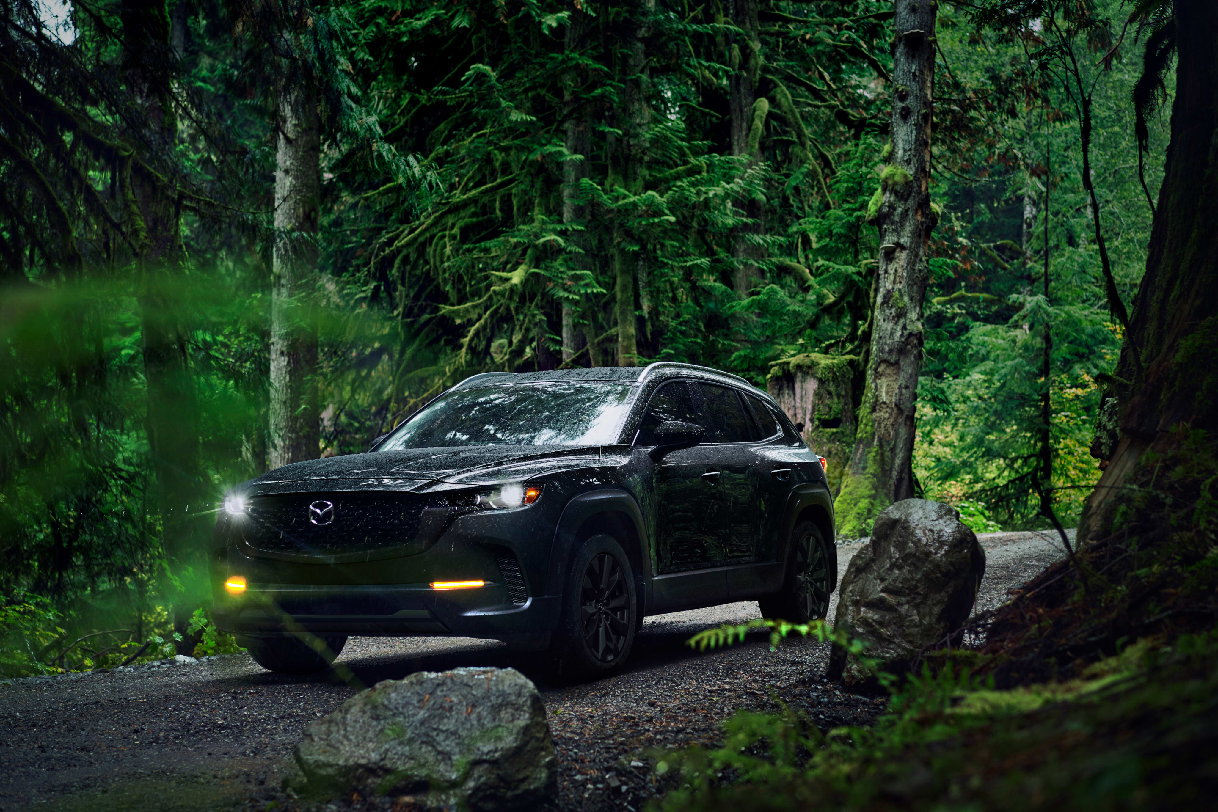 2026 Mazda CX-50 driving through trees