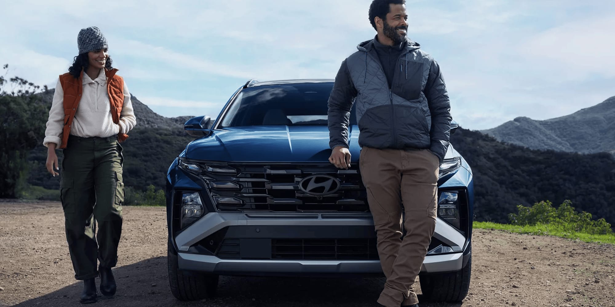 People standing next to parked 2026 Hyundai Tucson
