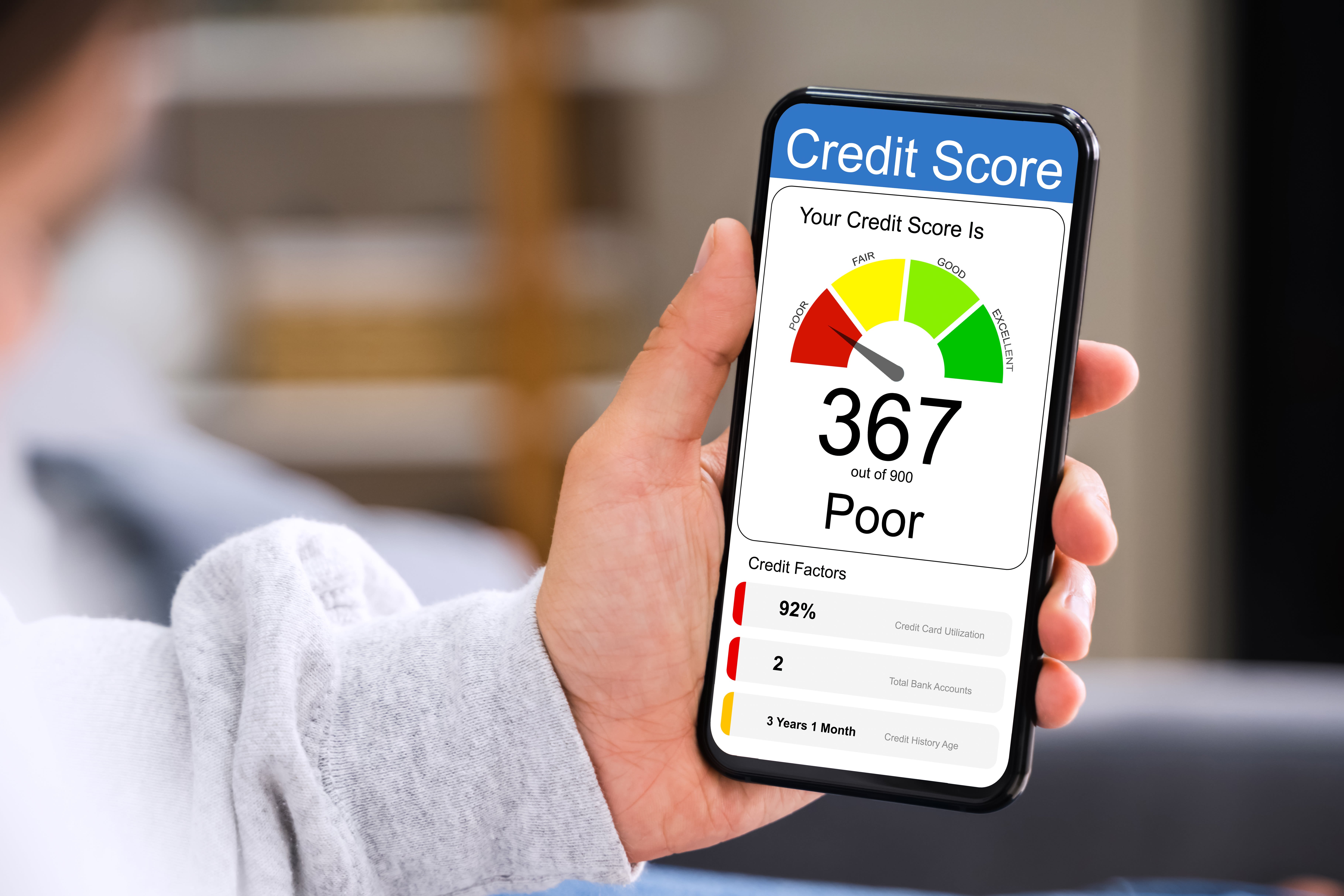 person holding mobile phone showing credit score