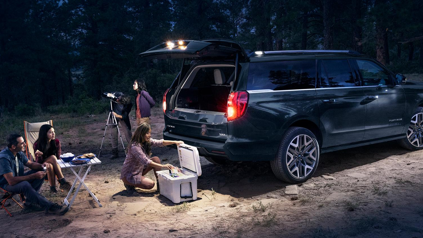 family set up with chairs and telescope at night next to expedition