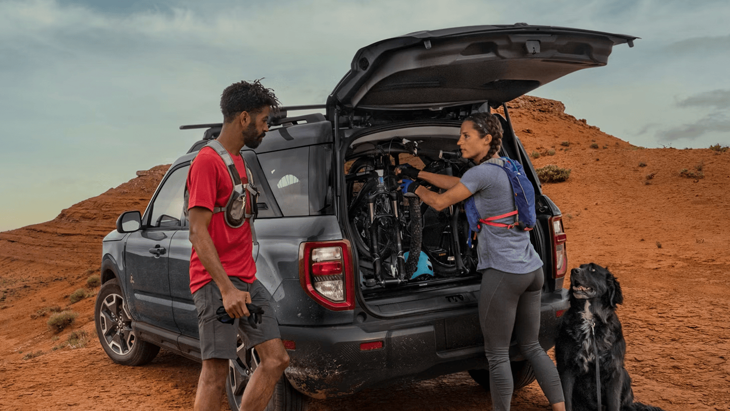 a couple loading bikes into the trunk of a 2026 Ford Bronco Sport