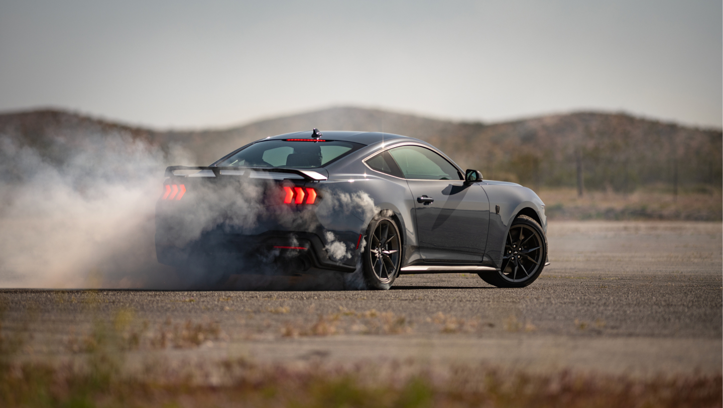 exterior 2026 ford mustang driving on a dirt road