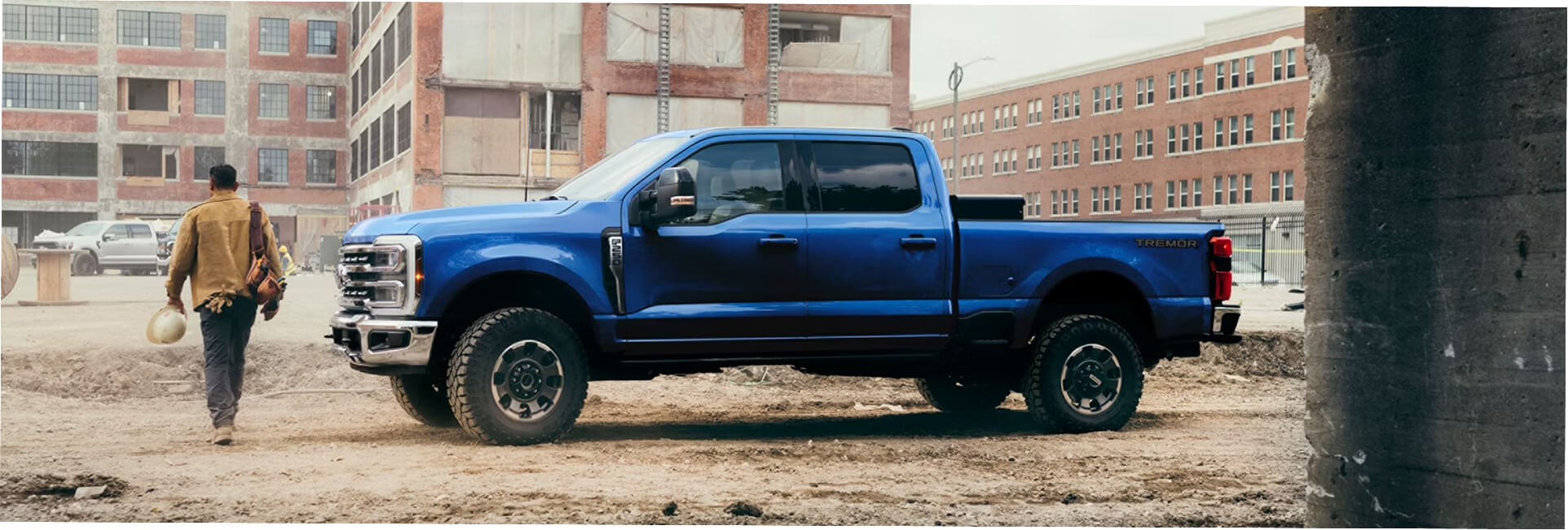 2027 blue ford f-250 parked in front of a construction site