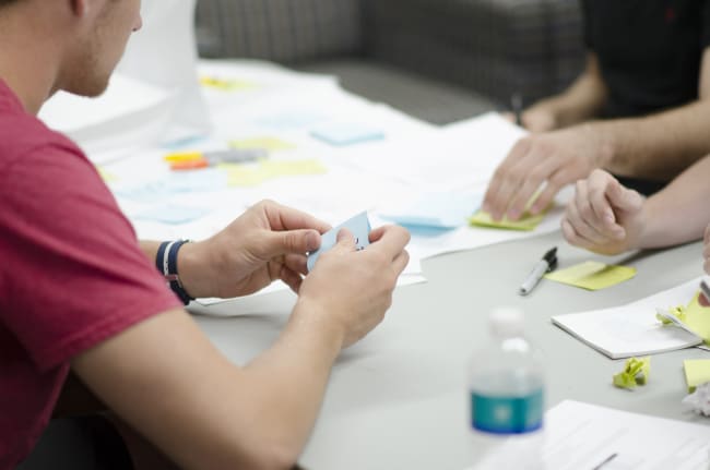 two developers planning an iteration of work using post-it notes