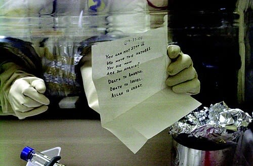 Laboratory technician holding an anthrax-laced letter sent to Senator Patrick Leahy.