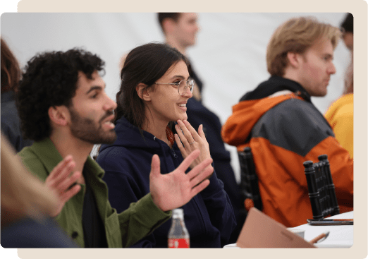 Attendees sitting at a table at an EAGx event