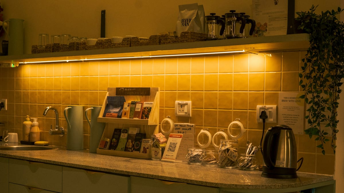 Kitchen counter tea station with a kettle and tea supplies