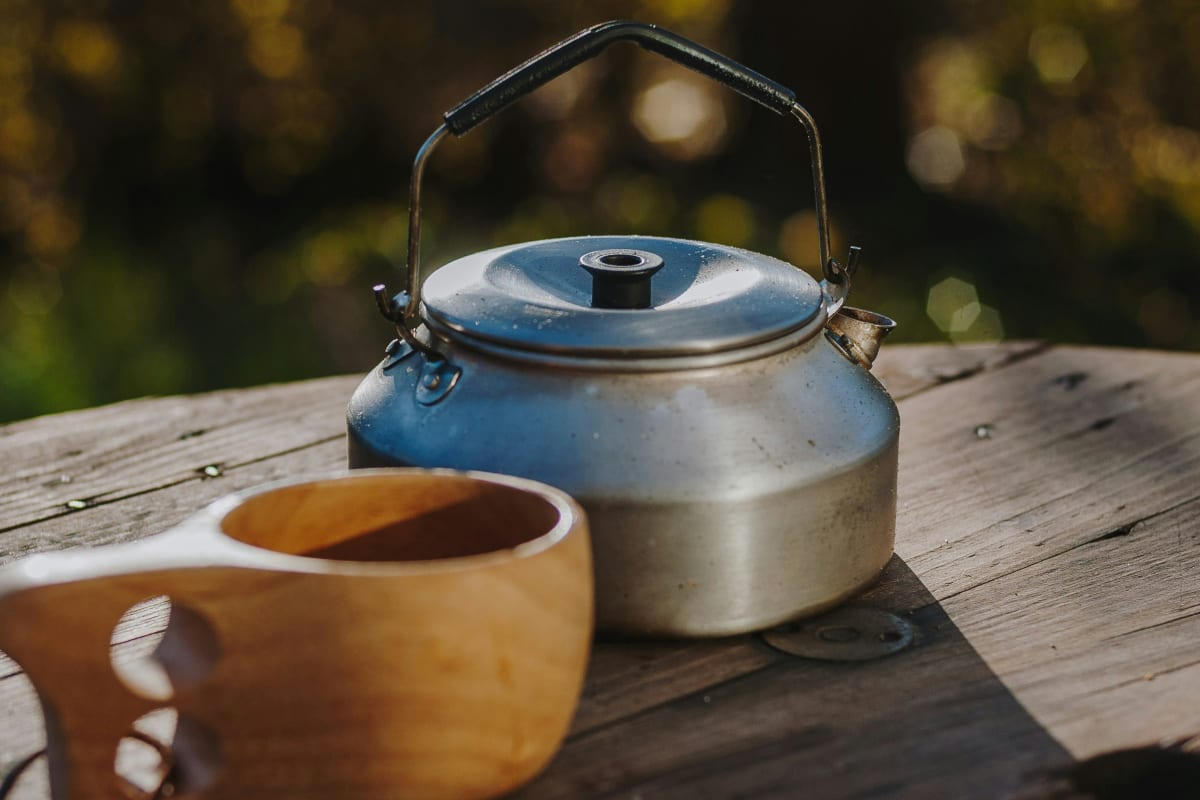 Camp kettle on a wooden table at a car camping site