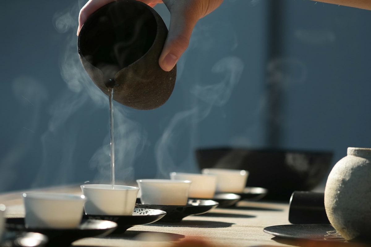 Pouring hot water during a traditional tea ceremony