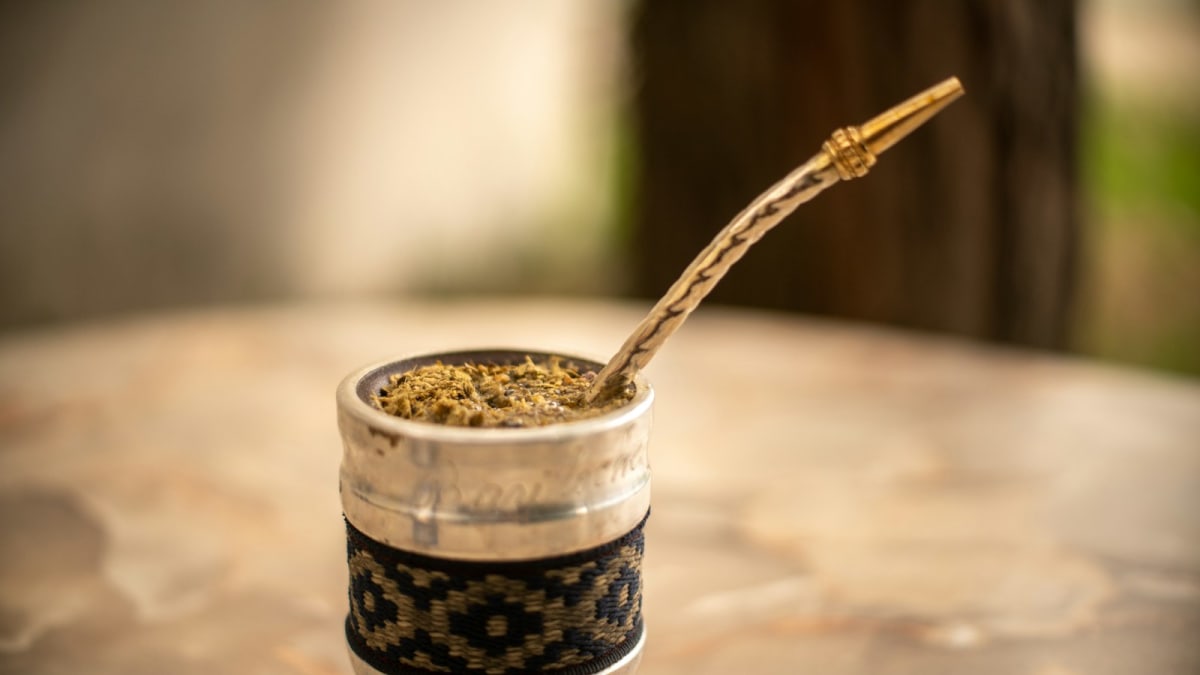 Traditional yerba mate gourd filled with yerba and a bombilla straw resting inside