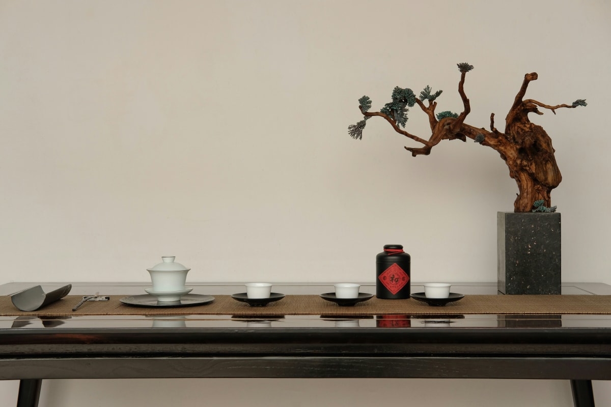 Collection of unglazed clay Yixing teapots displayed on wooden shelves