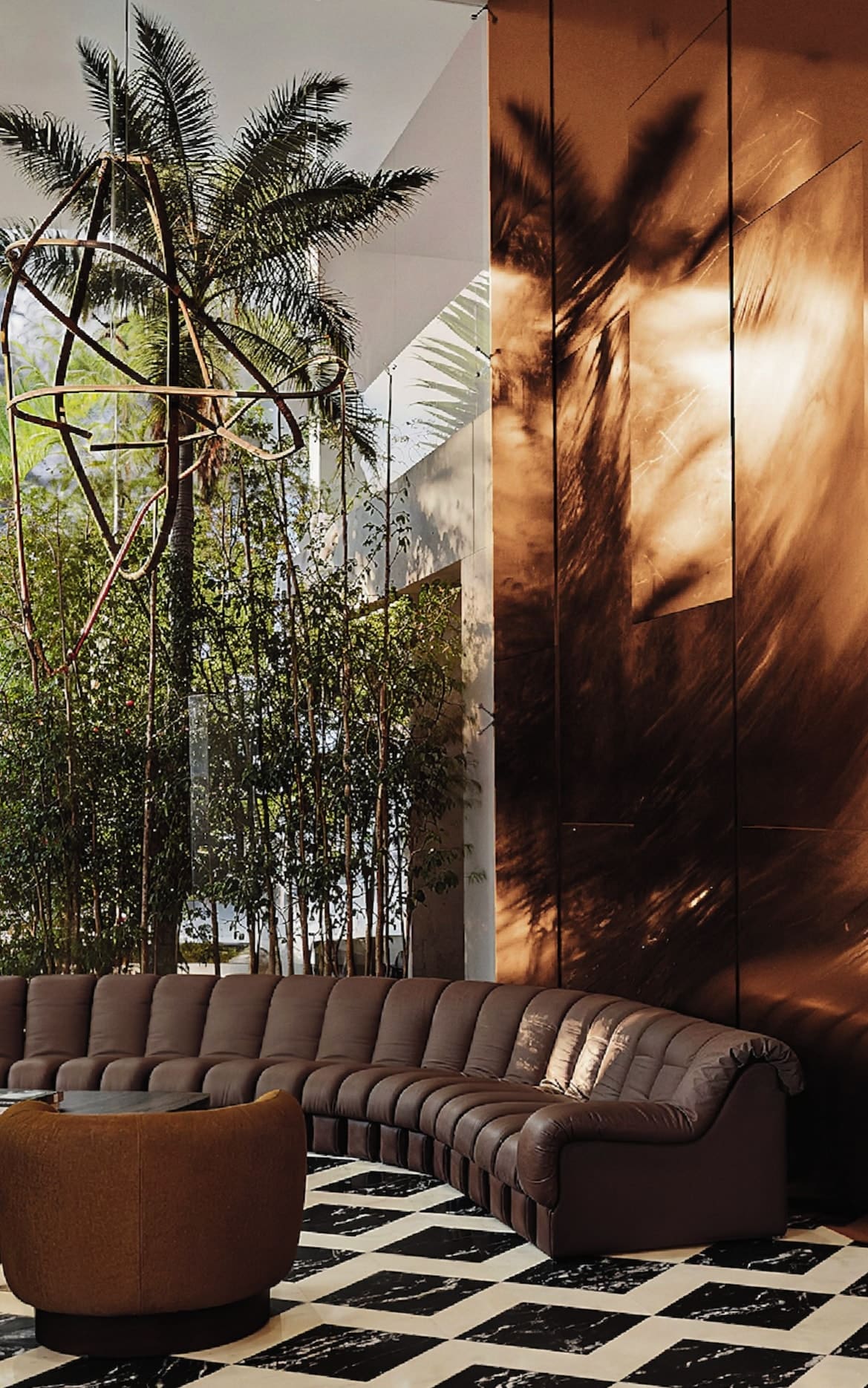 Double-height reception lobby with bespoke stone finishes and 24/7 concierge