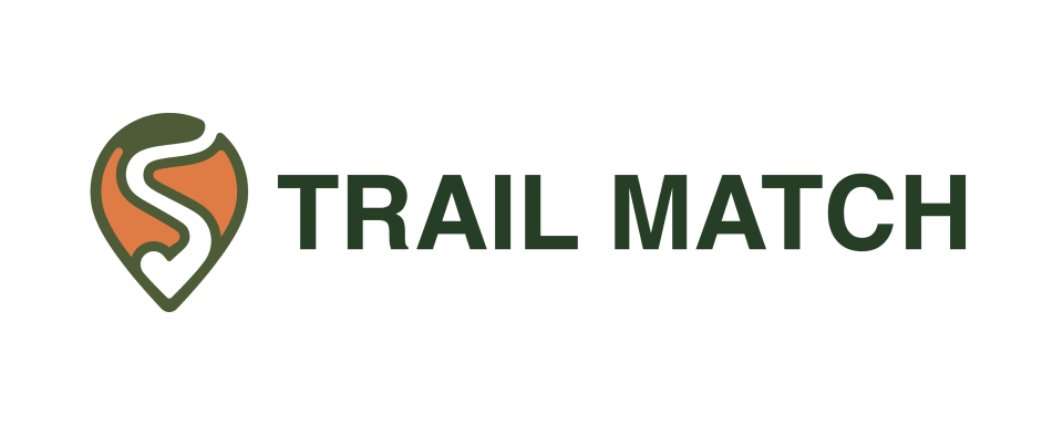 Trail Match logo featuring a green and orange location-pin-inspired emblem with a winding trail beside a dark-green uppercase wordmark.