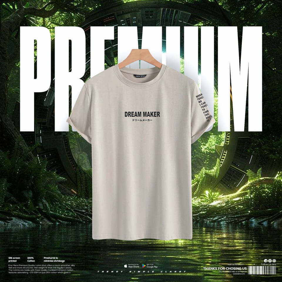 A floating beige premium t-shirt with the text "DREAM MAKER" hanging on a wooden hanger, displayed against a lush, overgrown jungle environment with sci-fi architectural elements.