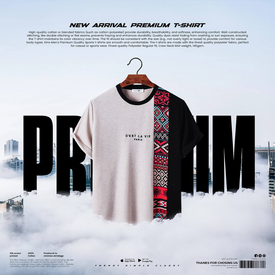 A premium t-shirt featuring a split design of light beige and black with a central colorful tribal pattern, suspended above a misty, cloudy cityscape with large "PREMIUM" typography.