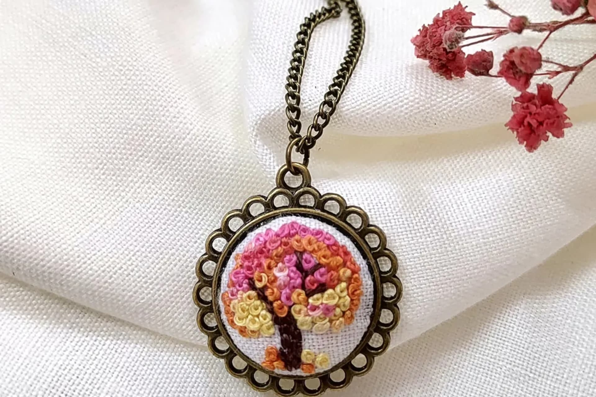 Tree of life embroidered pendant on white linen