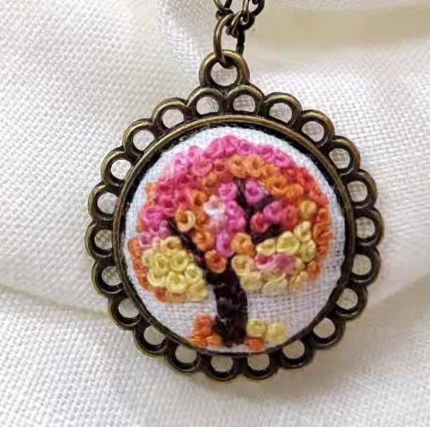 Tree of life embroidered pendant on white linen
