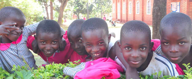African children pose for a photo in their school uniforms
