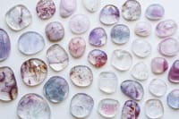 Selection of blue fused glass pieces, arranged on a white background