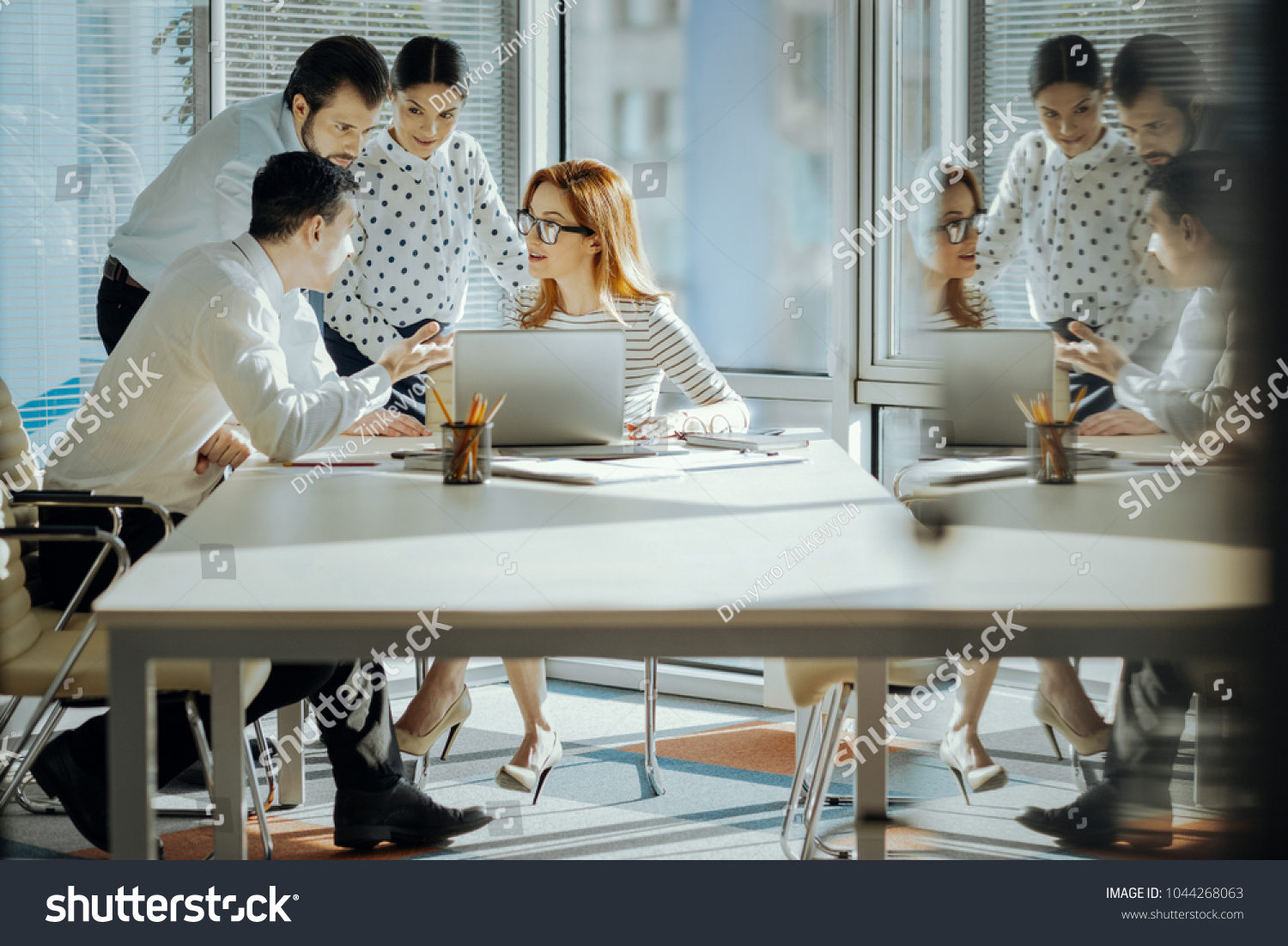 Stock photo providing feedback pleasant young employees watching a stock-photo-providing-feedback-pleasant-young-employees-watching-a